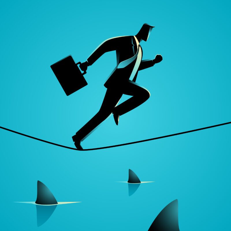 Man running on tightrope over shark-infested waters