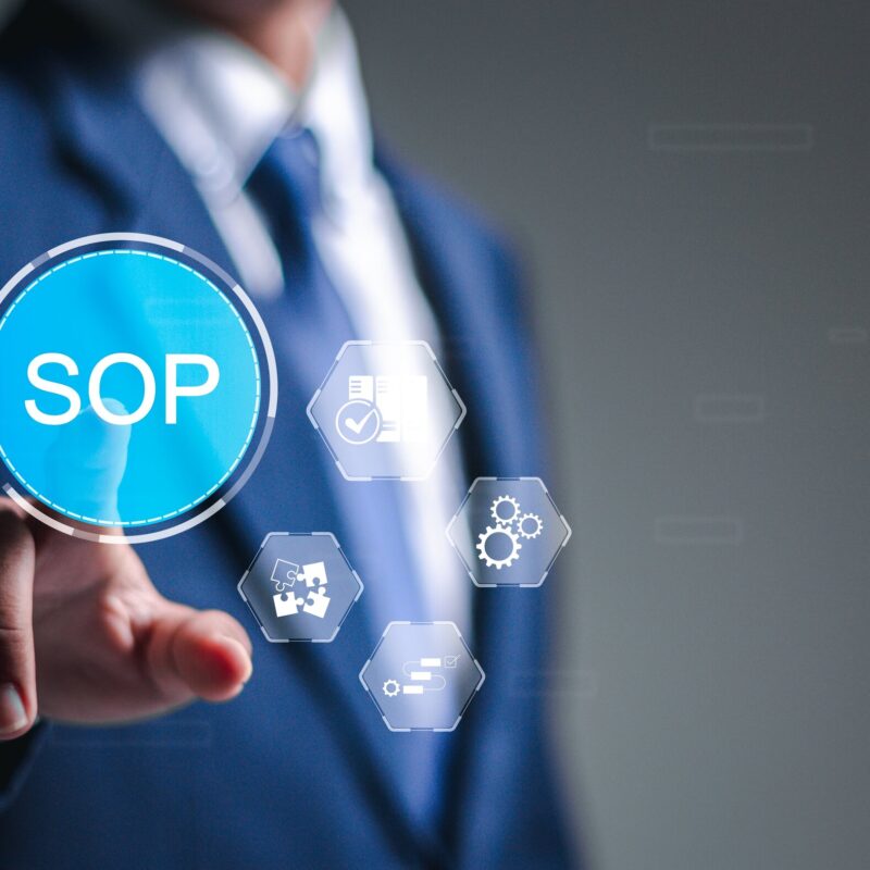 Person pressing a button that says "SOP"